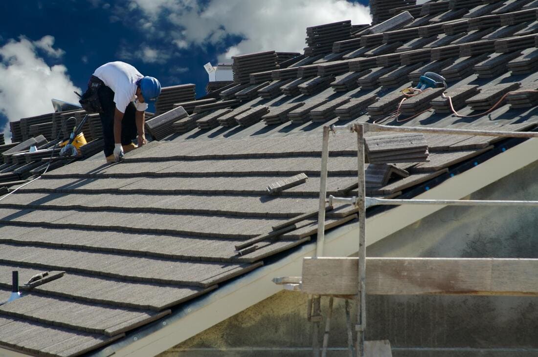 Roofers preparing a roof for installation